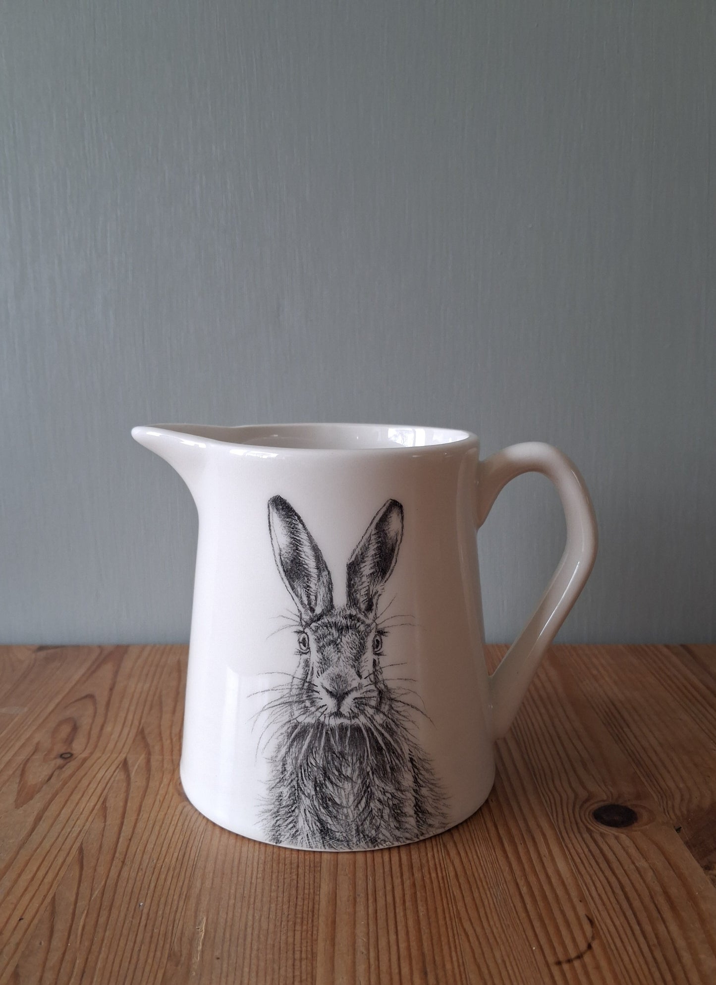 White ceramic milk jug featuring a hand drawn image of a hare.